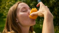 Junge Frau genießt eine Orange